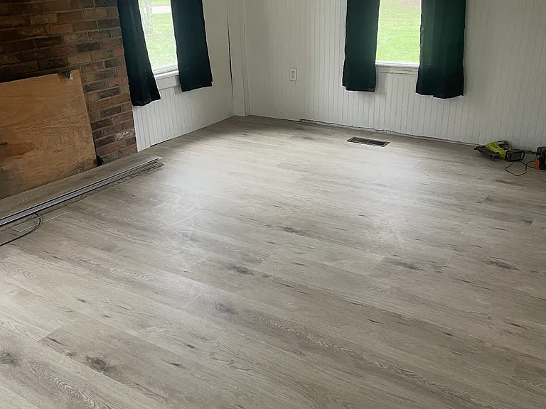 Living room with wood burning fireplace , 4 windows