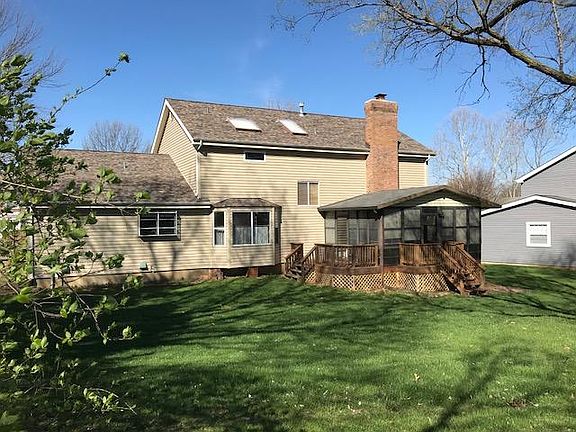 Large flat, open backyard with deck and 3 seasons room