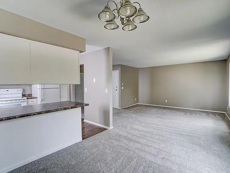 Dining room with kitchen island looking into living room