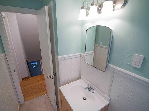 Half bathroom with plenty of storage in large closet