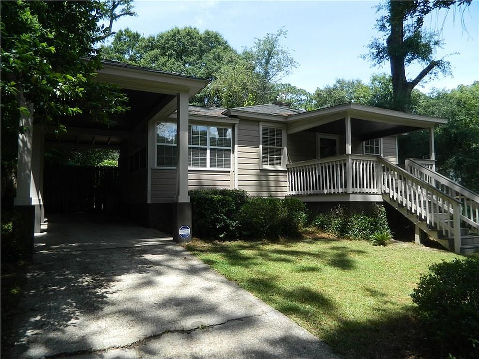 Welcome to 5218 Azalea Cir S! Driveway to Tall carport.