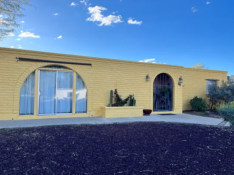 The front of the house has a gated porch with beautiful archway features_freshly painted in Fall 2024. A new Lennox HVAC system was installed in 2025, and a new roof in 2019.