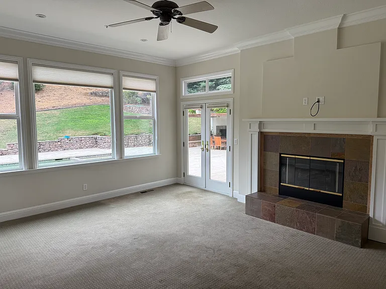 Primary bedroom with gas fireplace, and access to pool and outdoor kitchen and fireplace