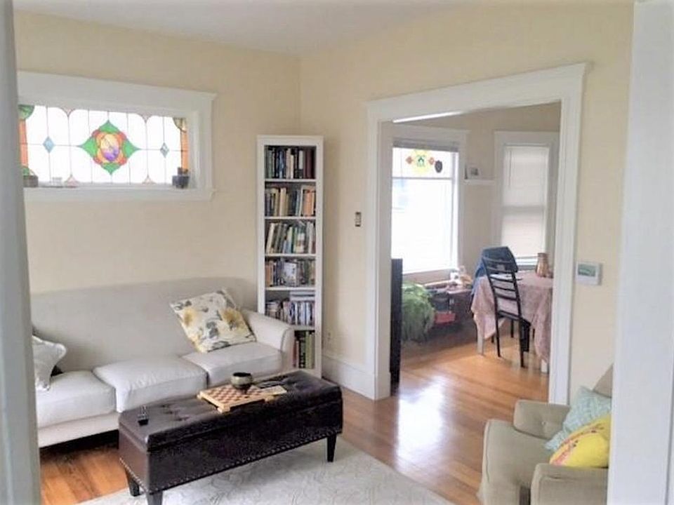 Living room with beautiful hardwood floor and stain glass window