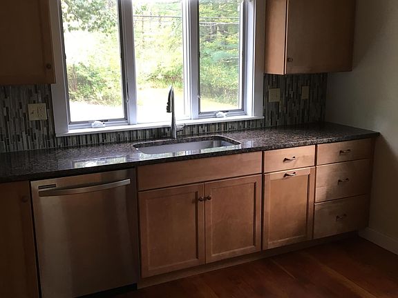 Kitchen equipped with granite counter-tops, hardwood cabinets, energy efficient lighting and hardwood floors throughout.