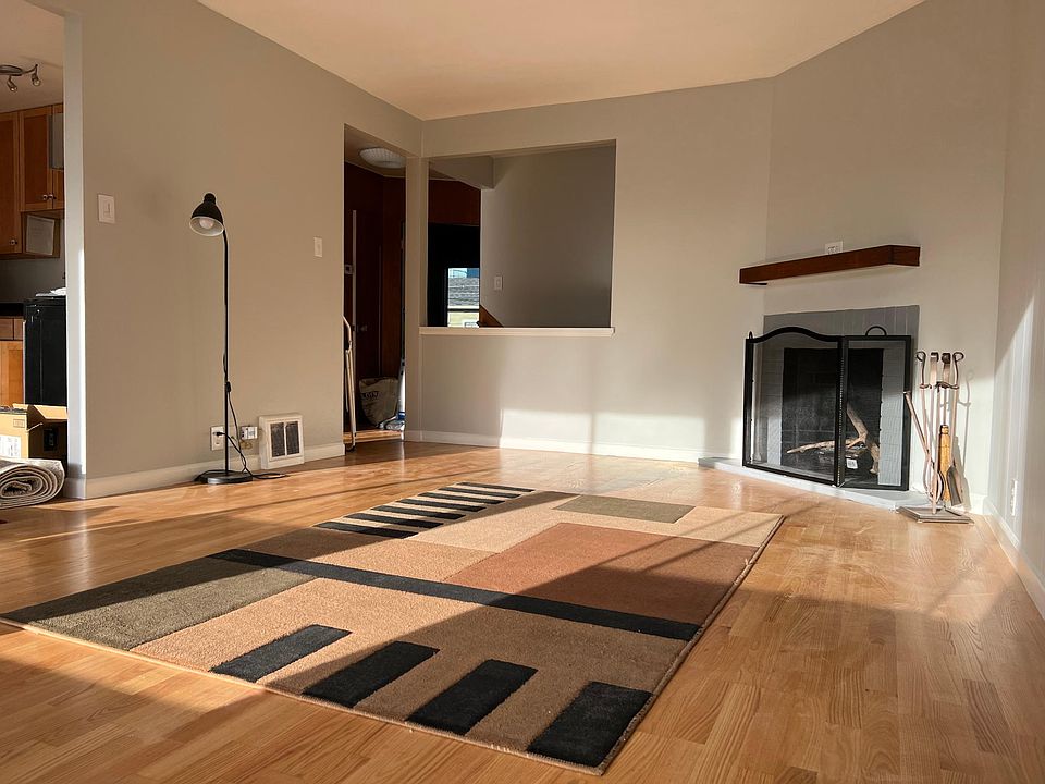Living Room looking toward hallway/entry staircase from back windows - new hardwood floors throughout apartment