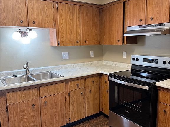 kitchen - new range, exhaust fan, counter tops, sink, garbage disposal,