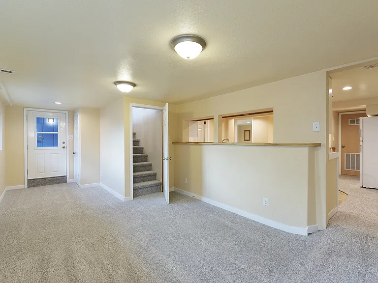 Downstairs - Living Room towards Interior Stairwell and Exterior Entrance