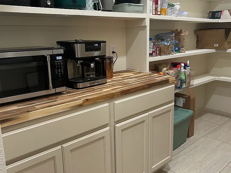 Spacious pantry with additional countertop space for appliances and other storage