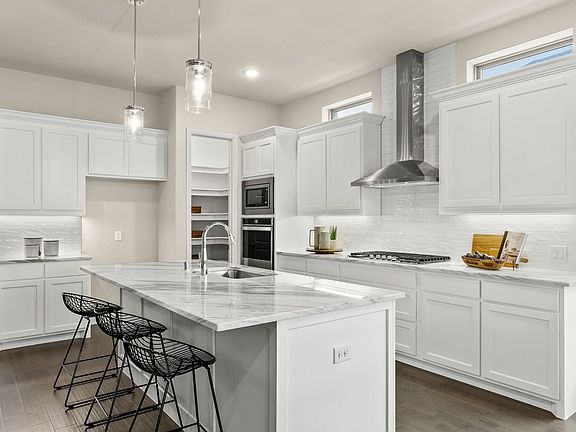 REPRESENTATIVE PHOTO - Kitchen in the Plaza home plan by Trophy Signature Homes