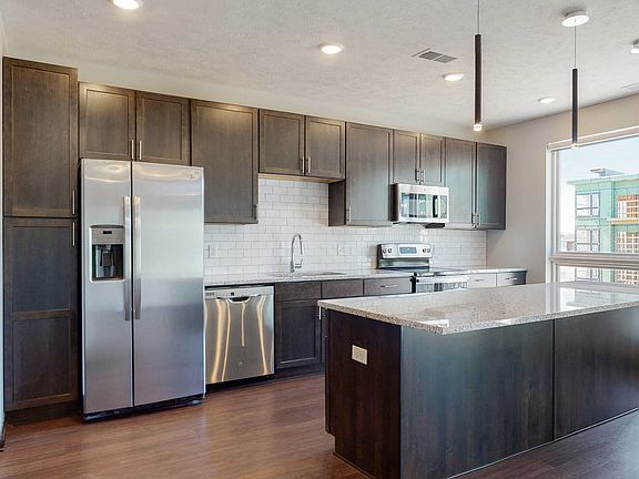 Our kitchens feature beautiful cabinetry, stainless steel appliances, and large islands, perfect for cooking and entertaining.