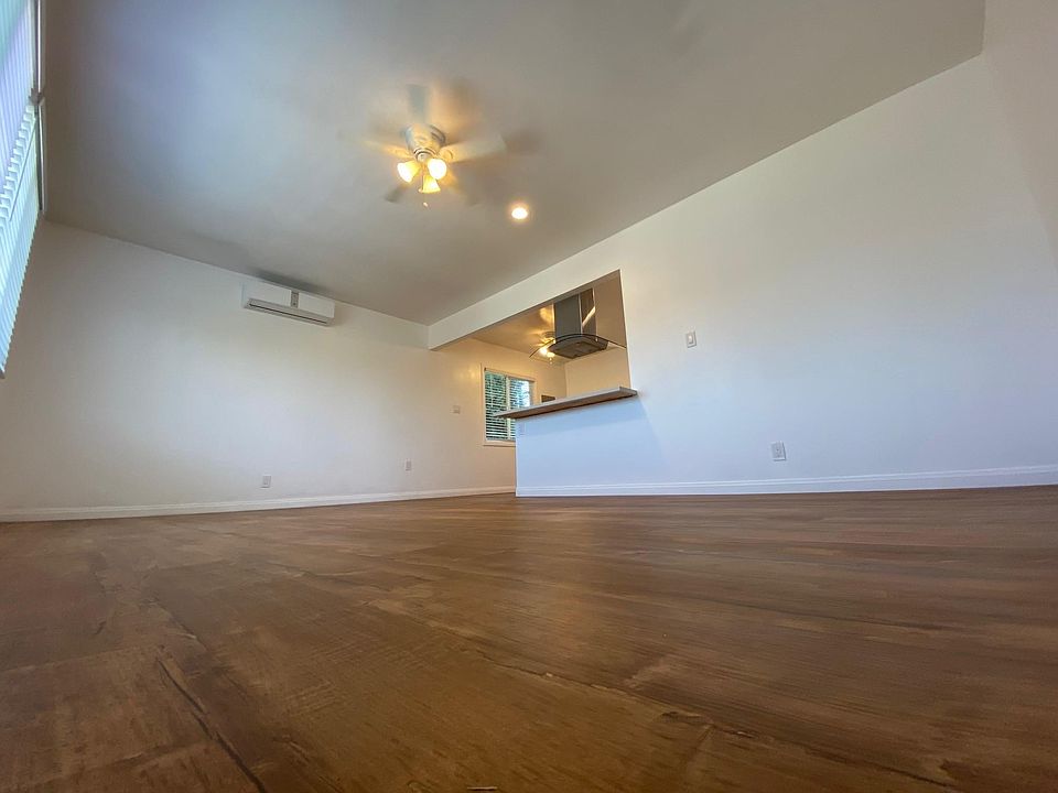 Living room and A/C. Newly installed A/C and ceiling fan. All new flooring.