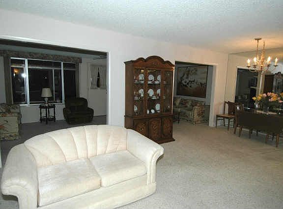 Behind the living room is the finished Arizona room and formal dining at right