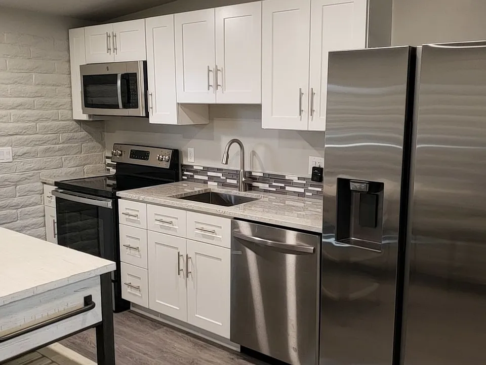 Modern kitchen completely remodeled with new appliances and granite coutertops