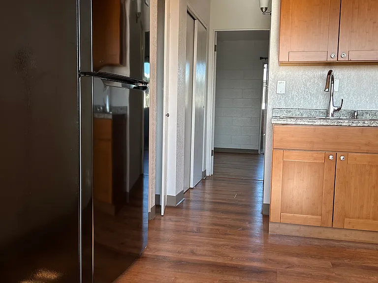 Hallway with closet on left and restroom on right side leading into bedroom #1
