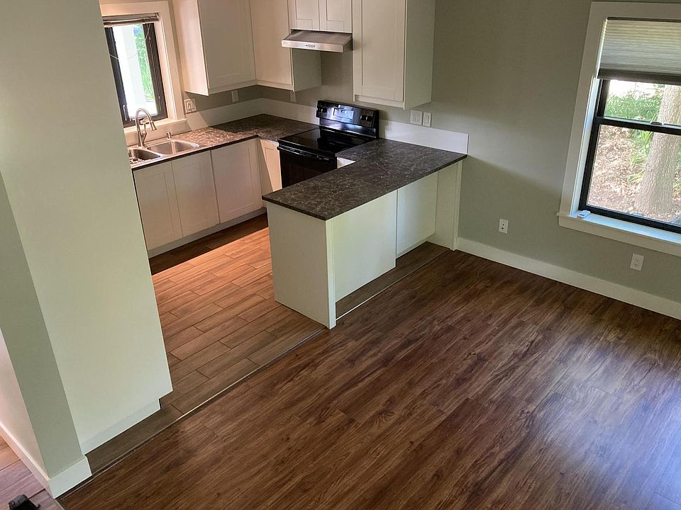 Looking from stairway down at kitchen and partial of living room.