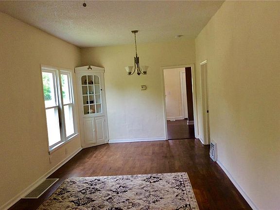 Living room/ dining room has hardwood floors & built-in China cabinet