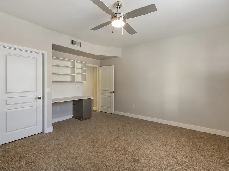 Enjoy a serene space with a desk for work and a ceiling fan for comfort