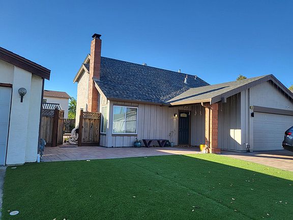 Artificial grass and pavers in front