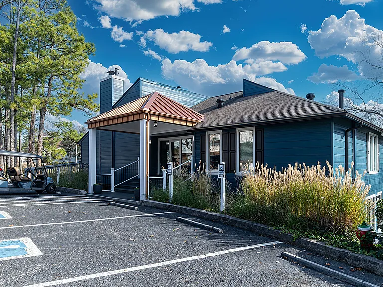 Experience cozy living in this charming blue cottage, perfect for a tranquil lifestyle.