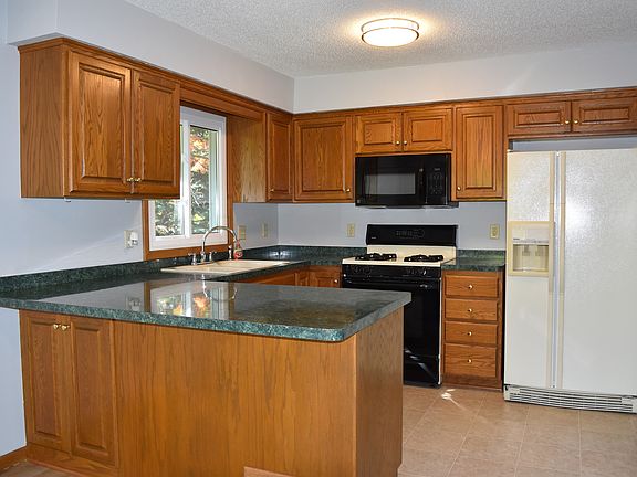 Double window looks out onto the backyard. Beautiful oak cab