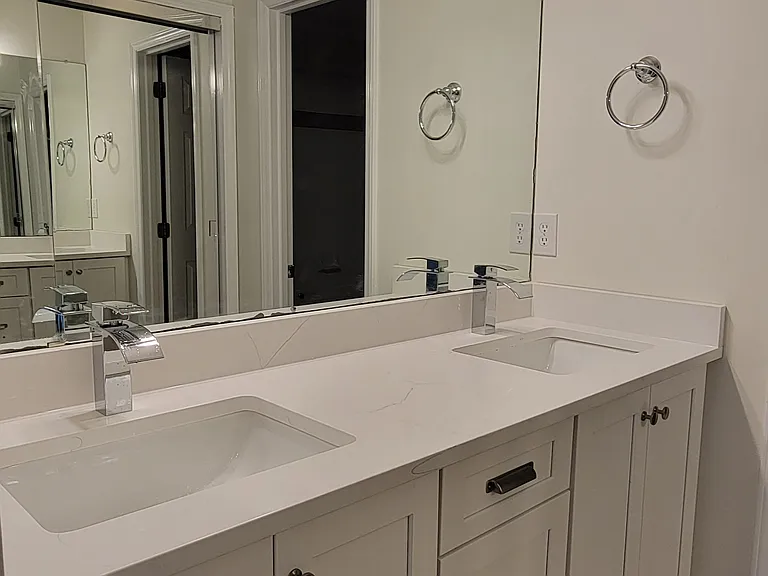 new vanity with quartz countertop and modern fixtures