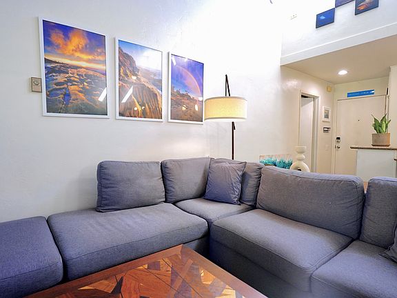 XL couch looking back at the front door and primary bedroom entrance