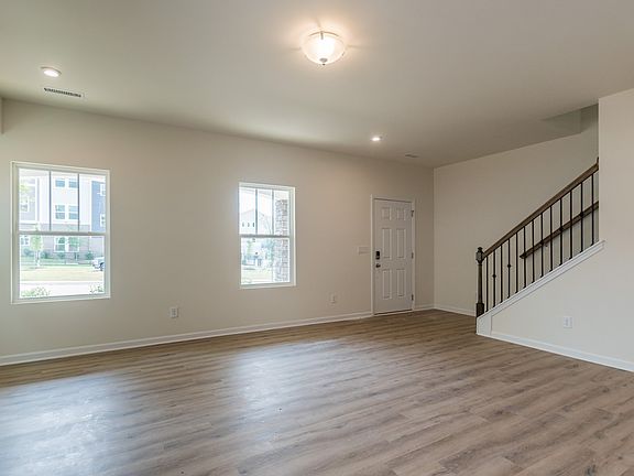 Large windows allow light to flood into the open-concept living space.