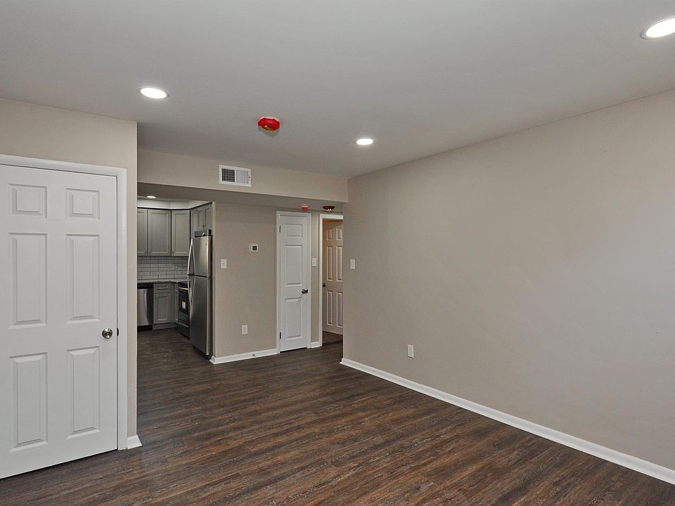 This is a view of the living room. You can see the kitchen and the hallway to the right