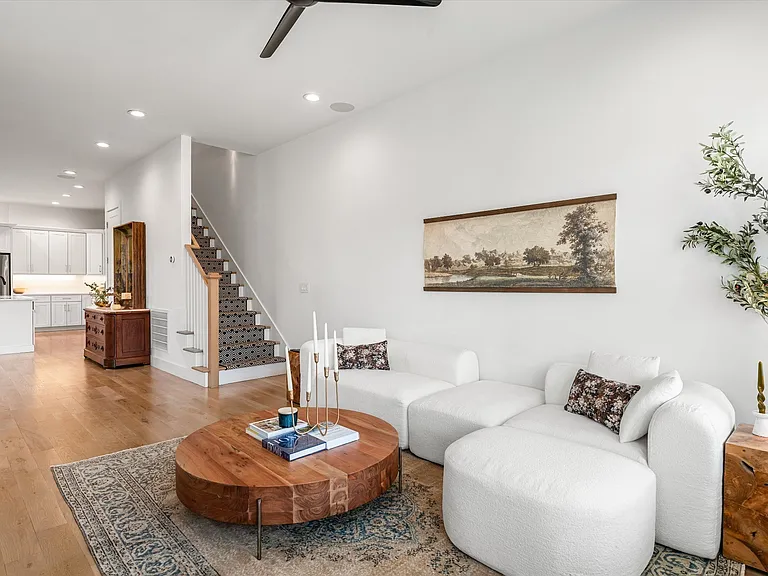 Open living area filled with natural light and seamless flow to kitchen and dining spaces.