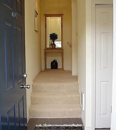 Private tile entry with newer carpet on stairs