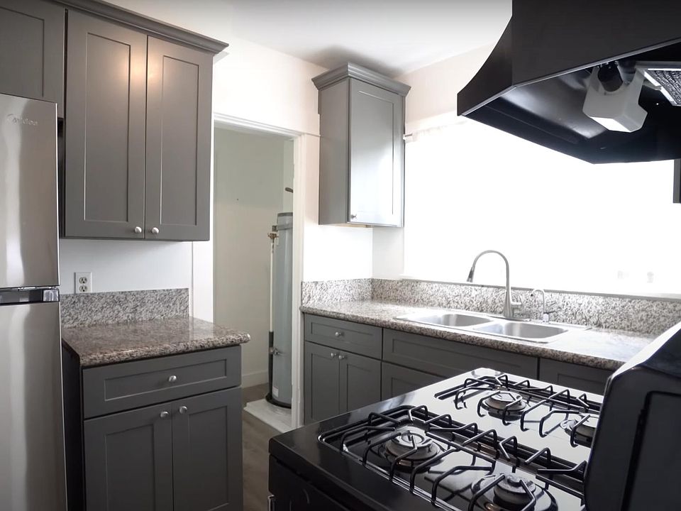 Kitchen features a gas oven, fridge (w/ freezer top), dual sink with garbage disposal, and ~10 shelves for storage. All appliances come with unit.