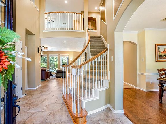If there's ever an entrance to take your breath away, this is it! As soon as you walk into the home you are greeted by the high ceilings of the foyer w/ a view of the beautiful curved stairway & living room just ahead.