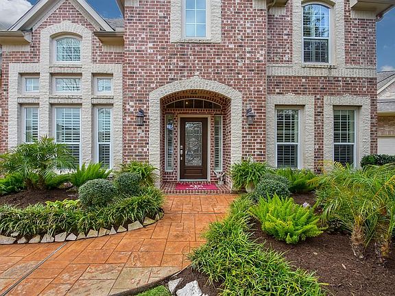 Extended stamped concrete sideway and custom landscaping add a touch of elegance that your guests will be sure to notice!