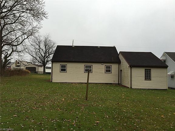 Back of home, nice size flat lot with side entrance door from garage to back yard