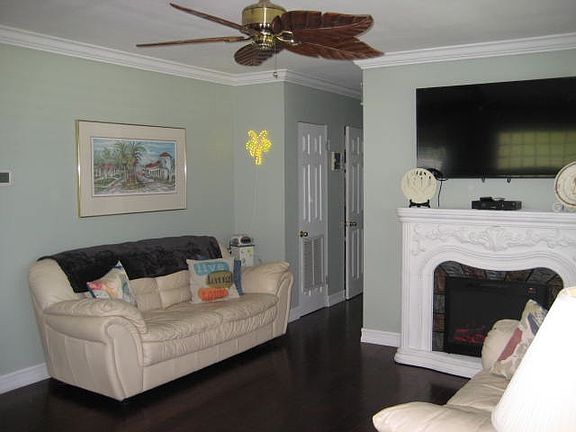 living room with fireplace and flat screen