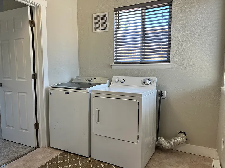 Convenient mudroom layout includes full-sized washer and dryer units. Move-in ready and fully equipped!