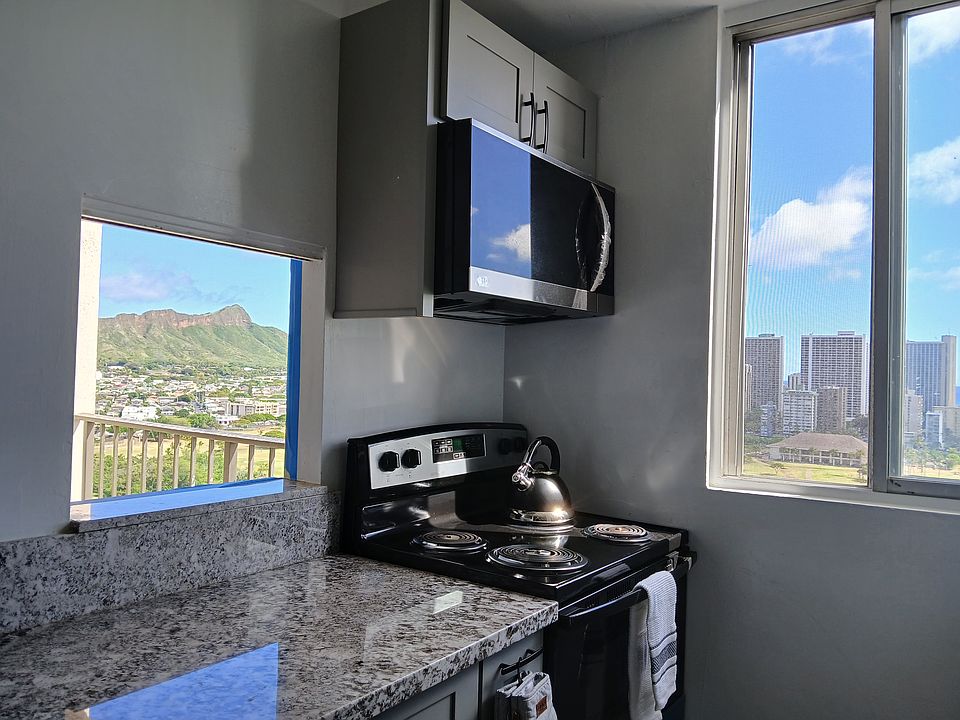 New countertop, microwave, stove and oven. Two open windows for cross breeze, a large standard window window and pass-through window to the lanai, with a view of Diamond Head.