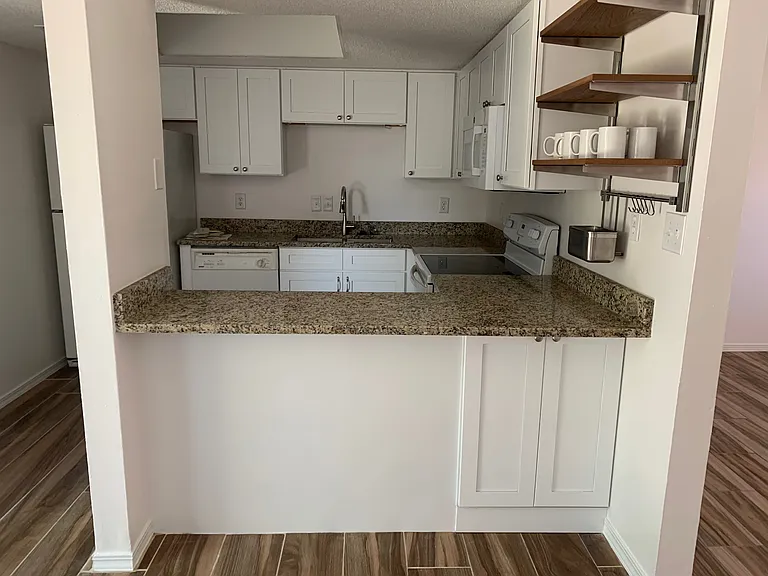 Bright kitchen with new cabinetry, granite countertops