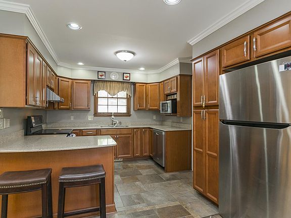 The remodeled and open kitchen offers ample cabinet and counter space and looks out over the large backyard.