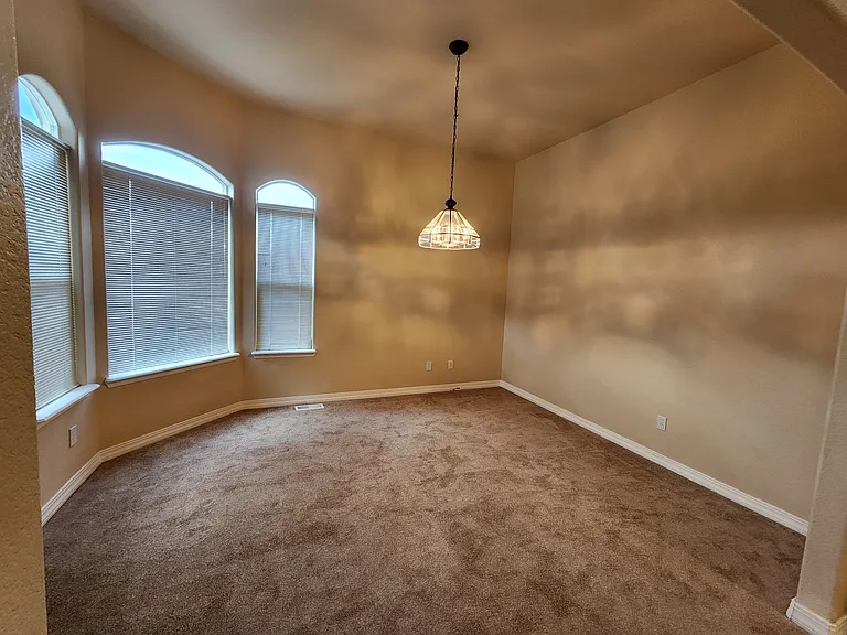 Master Bedroom Sitting Area with a view of the backyard and open space