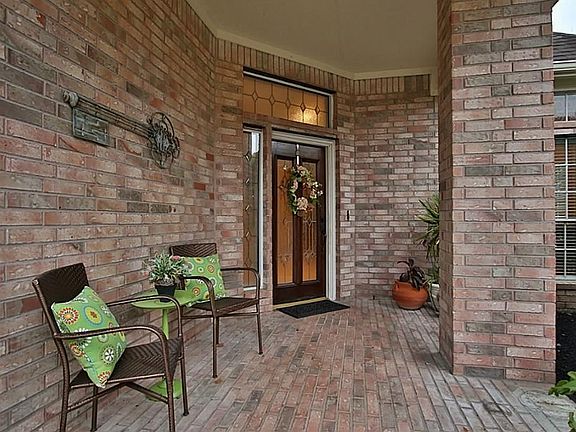 Large covered brick front porch greets you. This home is placed at the end of a cul-de-sac with brick fencing. Lean glass sidelight and transom add that custom touch.
