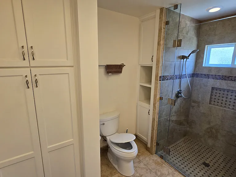 Bathroom includes large floor to ceiling Linen Cabinet