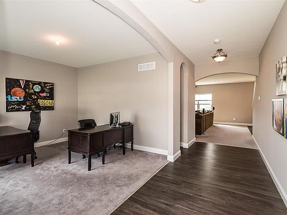 Large open entry showcases the arched doorways and 9ft ceilings.  Home office or possibly formal dining room.