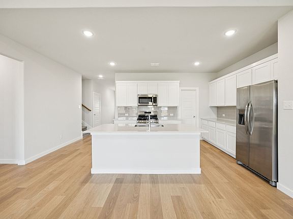 Kitchen in the Masters home plan by Trophy Signature Homes - REPRESENTATIVE PHOTO