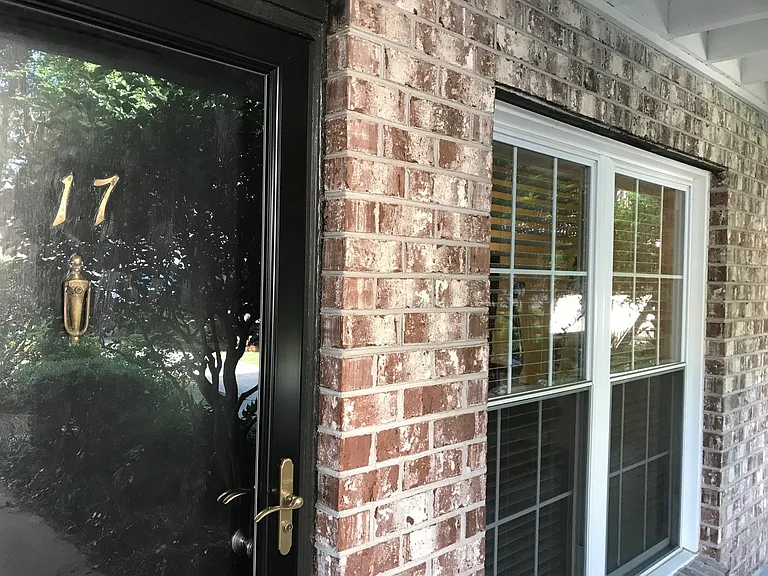 Photo from the courtyard of the door and living room window