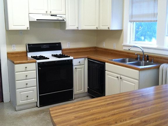 Kitchen with large island/bar separating from back door and