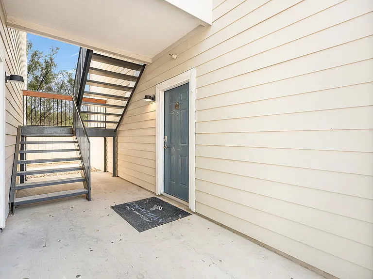 La Joya Apartments exterior in Laredo, Texas, with a hallway and stairs ascending to a door
