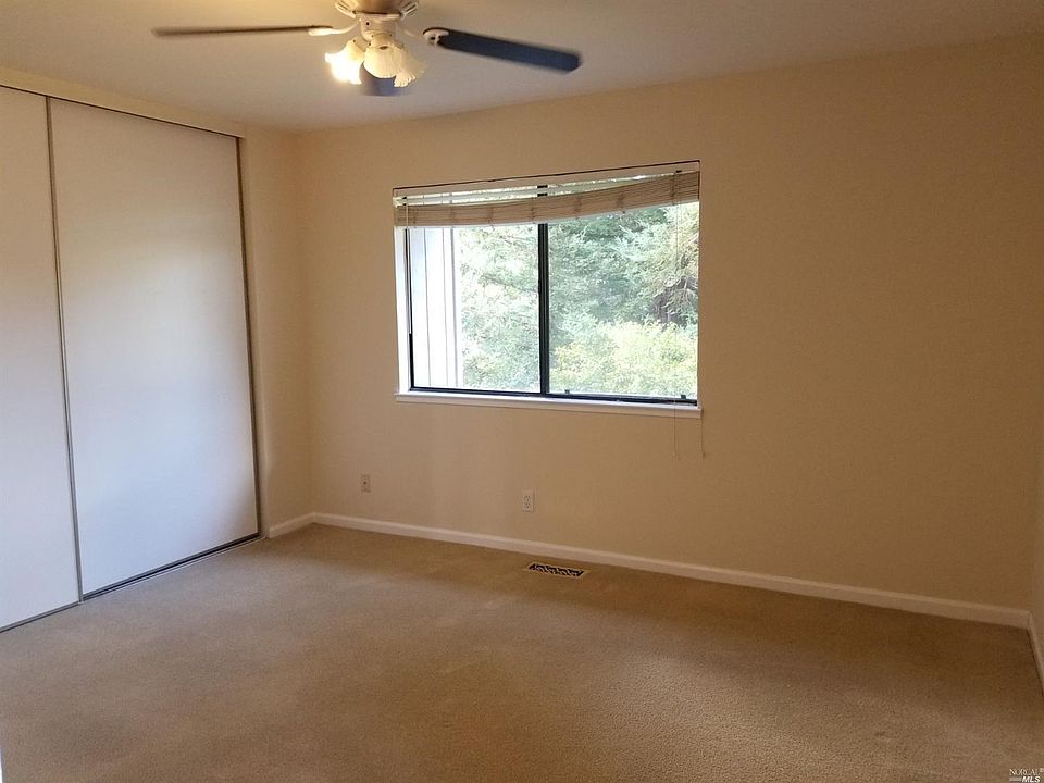 Master bedroom is large with triple closet, view of Redwoods and hills.