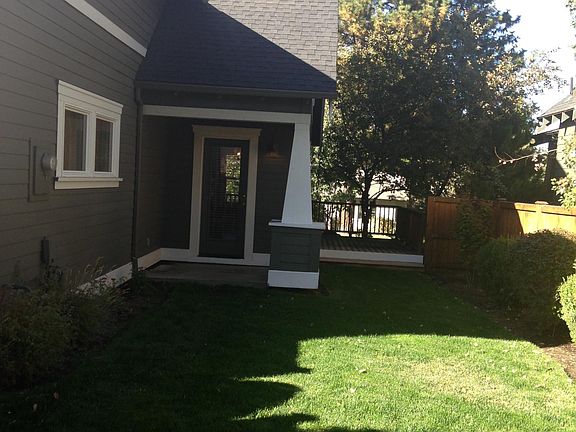 Fenced back yard with side porch and small back covered area.
